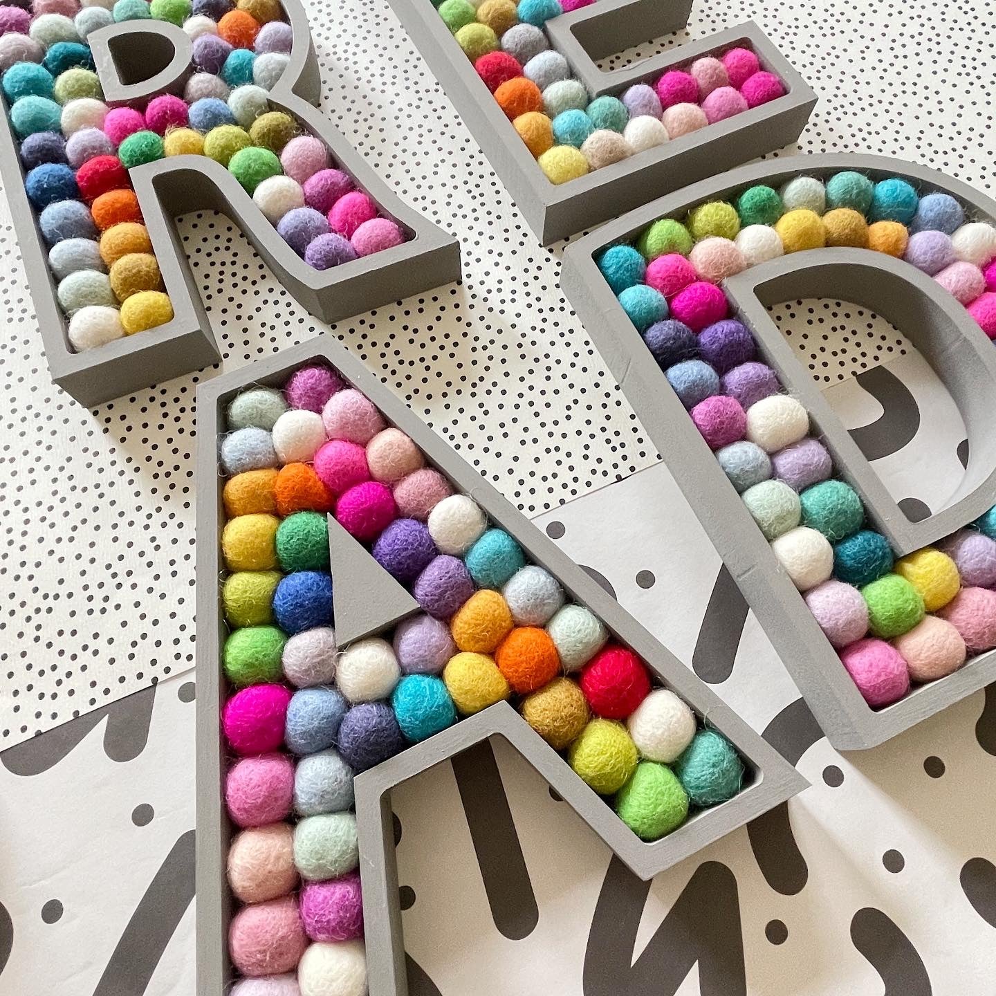Wooden Rainbow Pom Pom Letter - 20cm Dark Grey